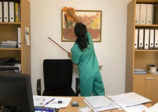 facility management cleaning person cleaning office